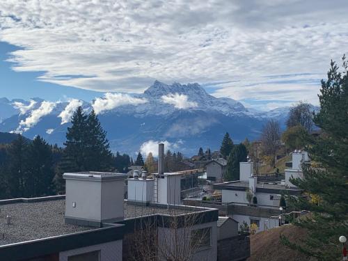 a view of a mountain from a city with buildings at Roc d'Orsay C15 in Leysin