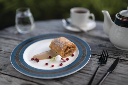a plate with a piece of food on a table at VARU by Atmosphere - Premium All Inclusive with Free Transfers in North Male Atoll