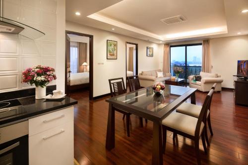 a kitchen and living room with a table and chairs at Elegant Suites Westlake in Hanoi