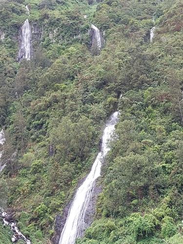 a waterfall on the side of a mountain at Chez Framboise in Salazie