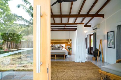 an open door to a bedroom with a bed at Pondok Santi Estate in Gili Trawangan