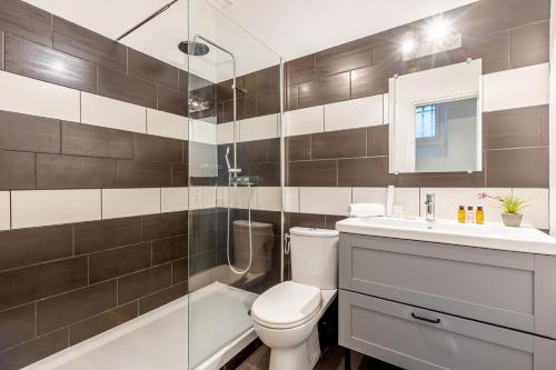 a bathroom with a toilet and a sink and a shower at Sweet Inn - Friedland in Paris