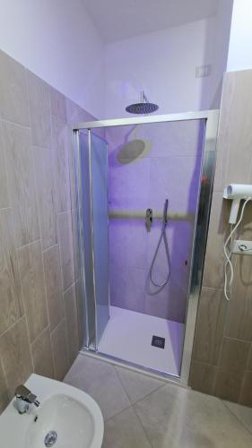 a bathroom with a shower with a toilet and a sink at Hera Tropea Rooms in Tropea