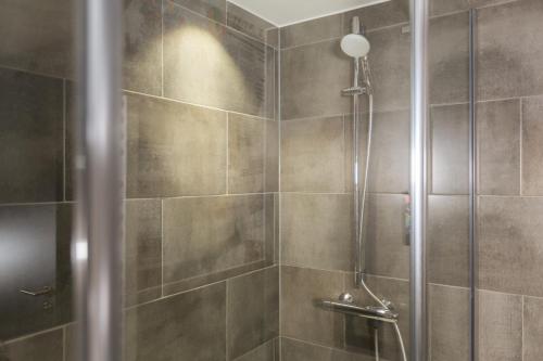 a bathroom with a shower with a glass door at Holiday Inn - the niu, Coin Frankfurt Ostend by IHG in Frankfurt/Main