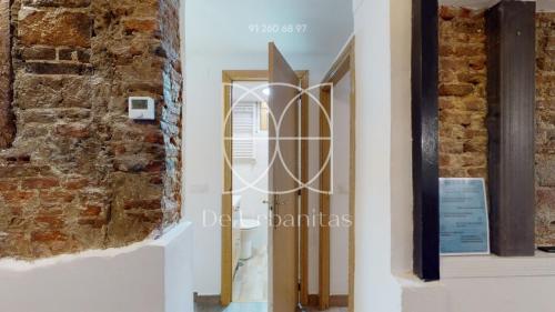 una puerta en una habitación con una pared de ladrillo en Velarde en Madrid