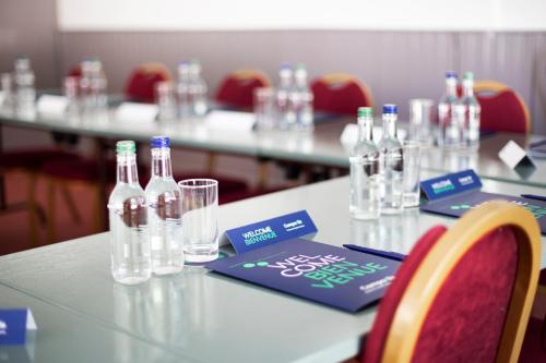 a table with bottles and glasses on top of it at The Raceby Hotel, Part of AG Collection in Doncaster