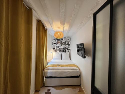 a small room with a bed and a window at Villette & Canal - Apartment in Paris