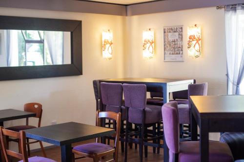 a dining room with purple chairs and tables at Campanile Hotel Doncaster in Doncaster
