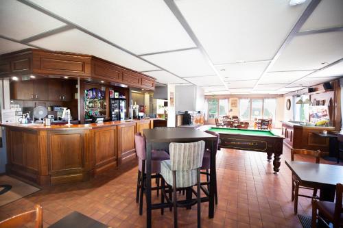 a room with a bar and a pool table at The Raceby Hotel, Part of AG Collection in Doncaster