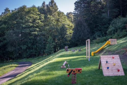 a playground with play equipment in the grass at Chalupa na mechu in Prostřední Bečva