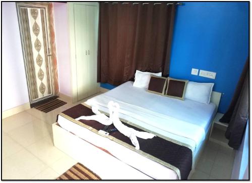 a bedroom with a bed with two people on it at Railview inn Bhubaneswar in Bhubaneshwar