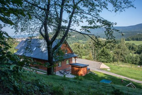 an aerial view of a house with a tree at Chalupa na mechu in Prostřední Bečva