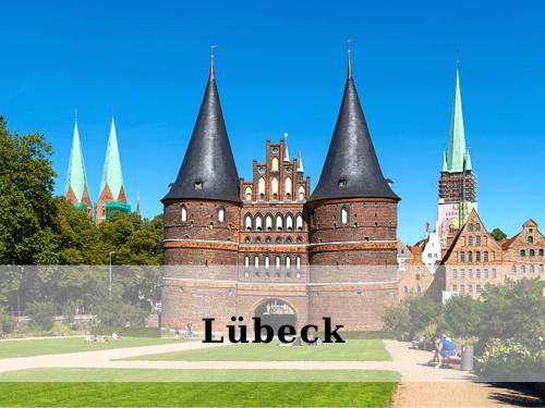a castle with black towers in a park at Top - Seaside Appartement mit Meerblick in Timmendorfer Strand