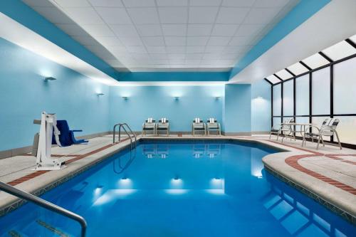 a swimming pool with blue walls and windows at La Quinta by Wyndham Newark - Elkton in Elkton