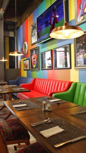 a dining room with a red couch and a table at Reef Hotel in Johannesburg