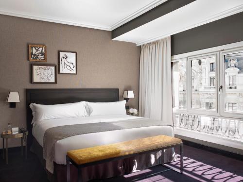 a bedroom with a large bed and a window at The Principal Madrid, Small Luxury Hotels in Madrid