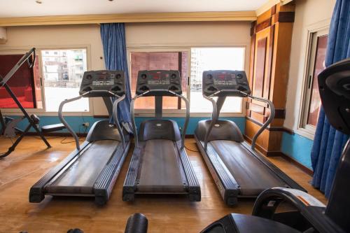 a gym with three treadmills on a train at AIFU Hotel El Montazah Alexandria in Alexandria