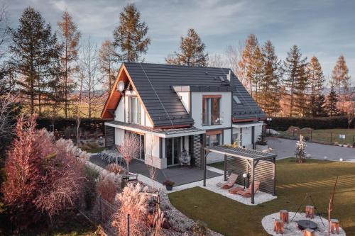 a small house with a black roof at Śnieżka Exclusive Apartamenty in Kowary