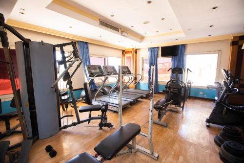 a gym with treadmills and machines in a room at AIFU Hotel El Montazah Alexandria in Alexandria