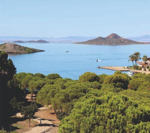 a view of a large body of water with trees at Konk Hostel in La Manga del Mar Menor