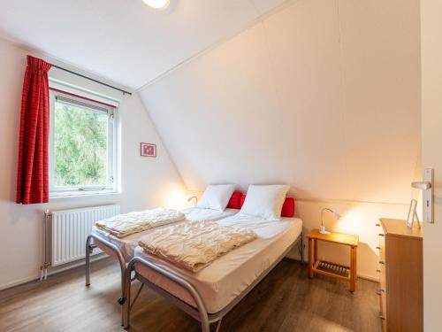 a bedroom with a large bed in a attic at Scenic holiday home in Schoonloo with garden in Schoonloo