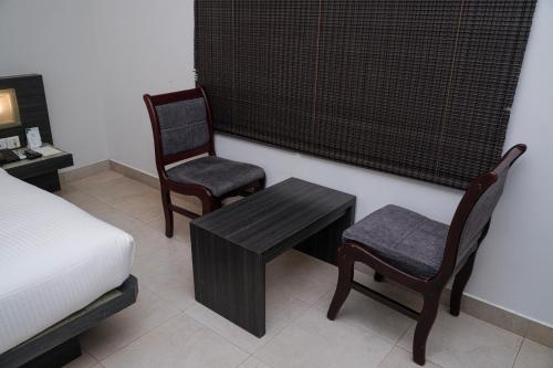 Postel nebo postele na pokoji v ubytování Hotel Palm shore