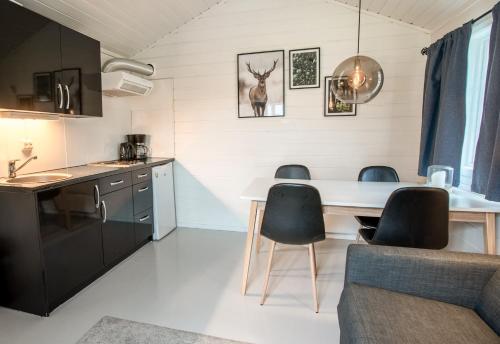 a kitchen and living room with a table and chairs at Koie Family in Stranda