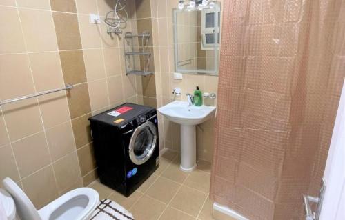 a bathroom with a washing machine next to a sink at The View 23 - B2 in Sharm El Sheikh