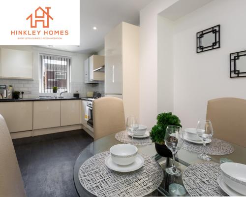 a kitchen and dining room with a table and chairs at 5 Beds - Free Gated Parking - City Centre - By Hinkley Homes Short Lets & Serviced Accommodation in Liverpool