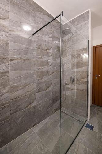a bathroom with a shower with a glass door at Dedinje apartment in Belgrade