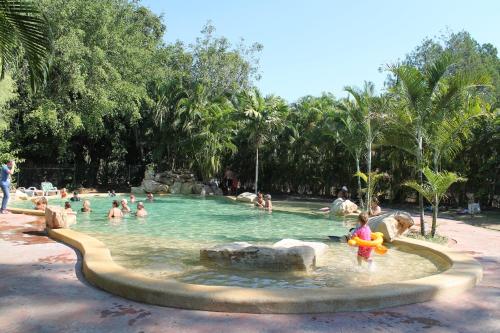 a group of people in a pool at a water park at BIG4 Howard Springs Holiday Park in Darwin