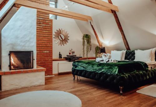 a bedroom with a green bed and a fireplace at Rataskaevu Boutique - 7 Unique Apartments in Tallinn