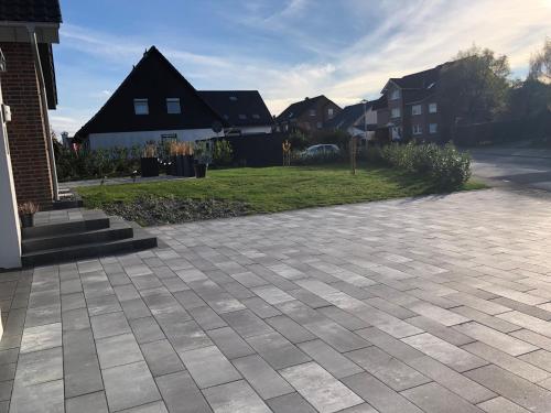 a brick driveway in a residential neighborhood with houses at Ferienwohnung am Teutoburger Wald in Berghagen