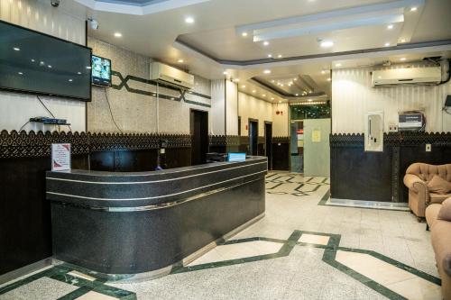 a lobby with a bar in a restaurant at Qaser Alhamra Serviced apartments in Riyadh