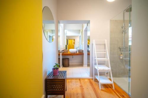 a bathroom with a shower and a sink and a mirror at Near Boavista - Free Parking in Porto