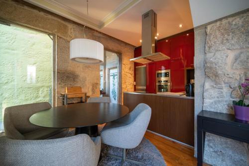 a kitchen and dining room with a table and chairs at Near Boavista - Free Parking in Porto