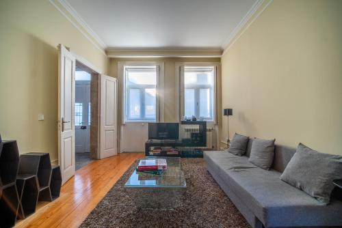 a living room with a couch and a table at Near Boavista - Free Parking in Porto