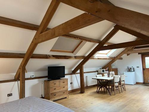 a bedroom with a bed and a table with chairs at The Old Stable - Flat 1 in Wadebridge