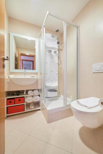 a bathroom with a shower and a toilet and a sink at Sunny apartament at Carcavelos Beach, by TimeCooler in Carcavelos