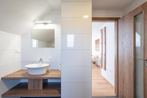 a bathroom with a sink and a mirror at Apartmány Oravskie in Zuberec