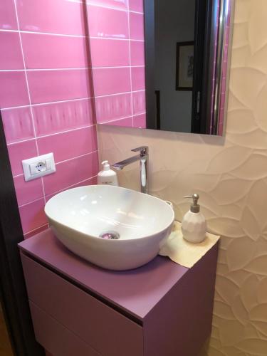 a bathroom with a white sink and a mirror at La Dolce Dimora degli Angeli in Rome