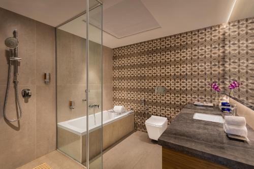 a bathroom with a shower and a toilet and a sink at Fortune Valley View, Manipal - Member ITC's Hotel Group in Manipala