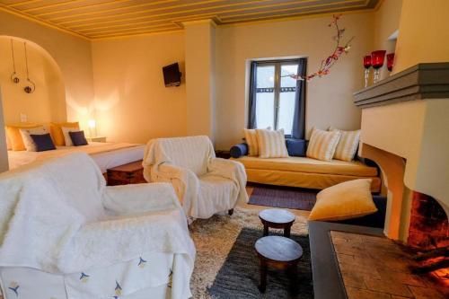 a living room with a couch and a fireplace at Kyriaki Guesthouse & Suites in Amfiklia