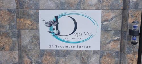 a sign on a wall with the sign for the supreme synergy spread at Déjàvu at the Bay in Richards Bay