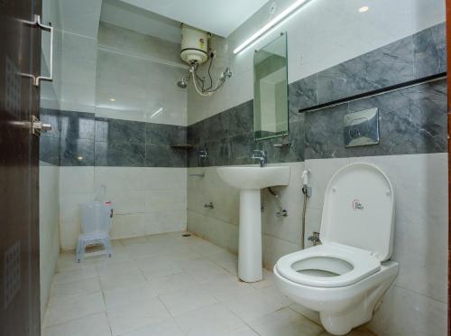 a bathroom with a toilet and a sink at HOTEL DOON in Dehradun