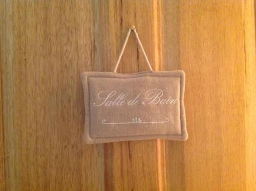 a sign is hanging on a wooden wall at Studio Indépendant Drôme Provençale in Puygiron