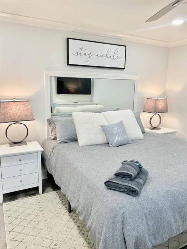 a bedroom with a bed and two tables and two lamps at Downtown! 24h Concierge! Private Balcony! Highrise Views in Atlanta