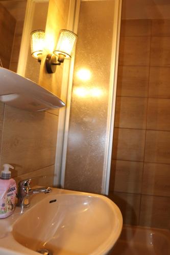 a bathroom with a white sink and a mirror at Hotel Berliner Hof in Düsseldorf
