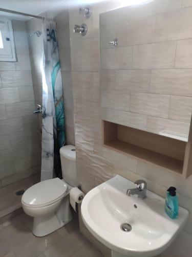 a white bathroom with a toilet and a sink at GCM 2 ROOMS kentro in Katerini