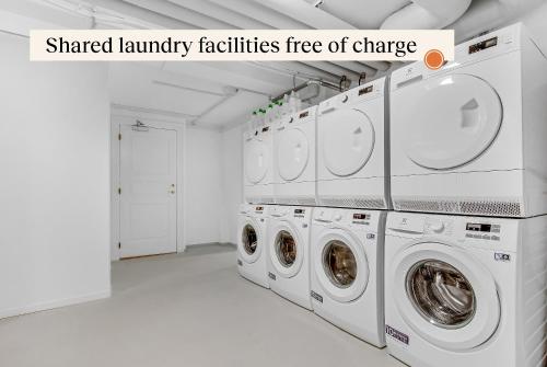 a laundry room with a bunch of washing machines at Apēron Apartment Hotel in Copenhagen